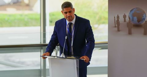 Businessman Delivering Speech at Seminar Podium
