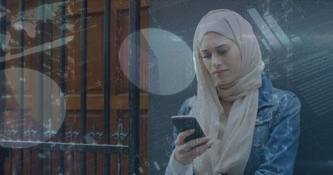 Middle eastern woman engaging with financial data on smartphone