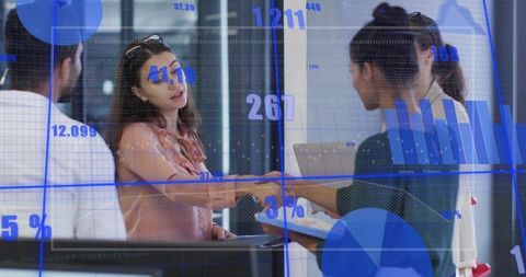 Business handshake at reception with data overlay showing collaboration and growth