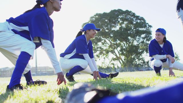 This illustrates diverse female baseball players engaging in squatting and stretching exercises on a sunny field. Useful for illustrating themes like teamwork, diversity in sports, athletic training, and outdoor physical activities. Ideal for articles or advertisements related to sports training equipment, team building exercises, and women in sports.