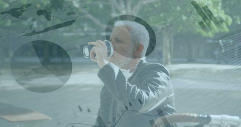 Businessman Analyzing Global Financial Trends with Laptops Outdoors