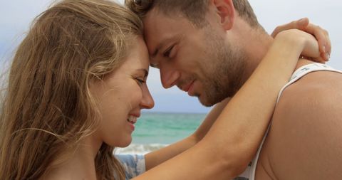 Loving Couple Embracing on Sunny Beach Shoreline - Download Free Stock Images Pikwizard.com
