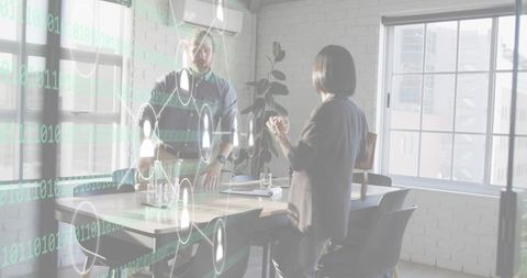 Corporate colleagues discussing digital collaboration with holographic data overlay