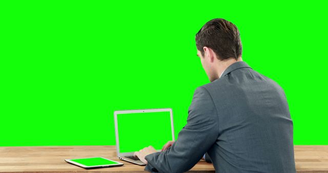 Businessman Working on Laptop with Green Screen Display in Office - Download Free Stock Images Pikwizard.com