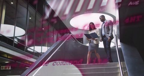 Diverse Colleagues Analyzing Financial Data in Modern Office Space