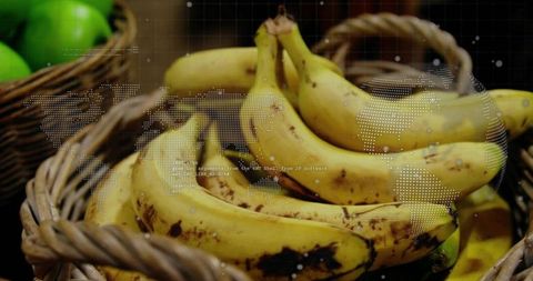 Ripe yellow bananas in woven baskets with green apples and global data overlay