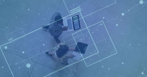 Business Professionals Examining Holographic Technology in Atrium