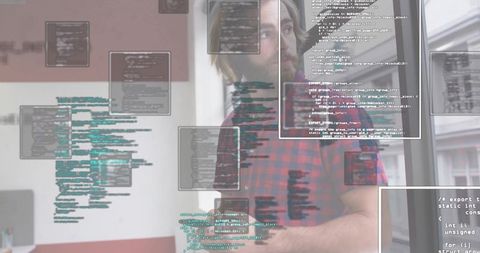 Developer typing code at office, red flannel shirt