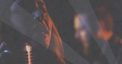 Moody female singer performing with vintage microphone in dim club lighting and smoke