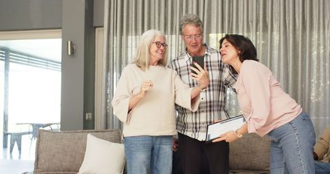 Therapist celebrating with diverse patients in group session