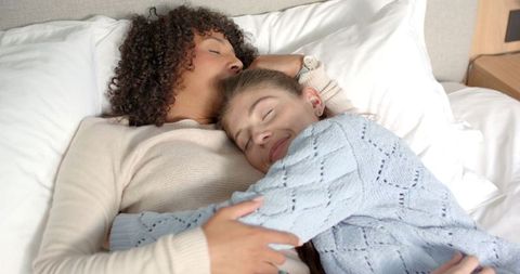 Diverse Couple Enjoying Peaceful Moment in Cozy Bed