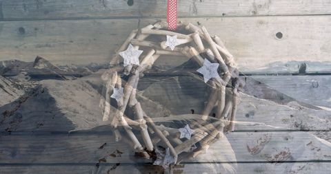 Rustic Christmas Wreath Overlaid on Winter Landscape