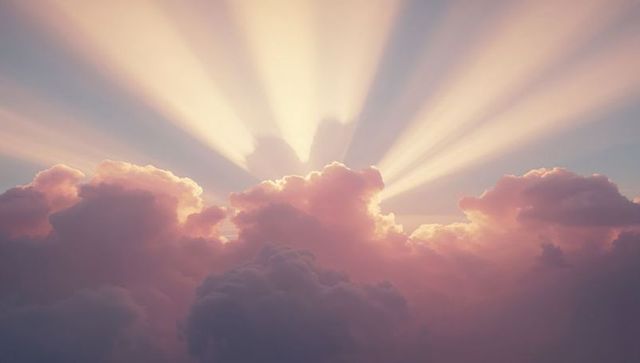 Golden Sunrays Illuminate Gentle Pink Cumulus Clouds