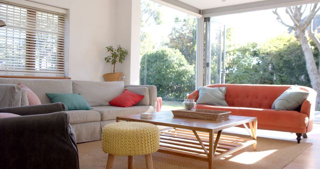 Close up of sunny living room with colourful pillows on sofa. Lifestyle, interior decor and domestic life, unaltered.