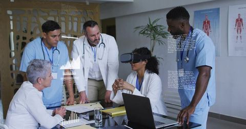Medical team training with VR headset, female doctor exploring virtual clinical simulation