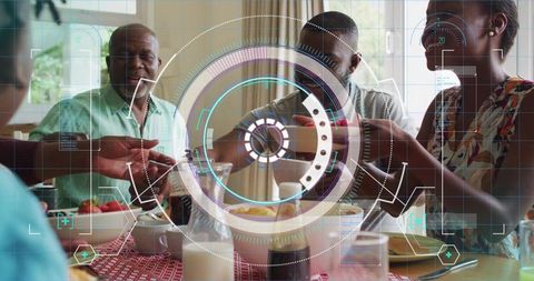 Multigenerational family sharing breakfast, passing dishes around table with hud overlay