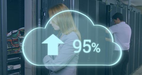 Stressed businesswoman with cloud upload graphic in server room