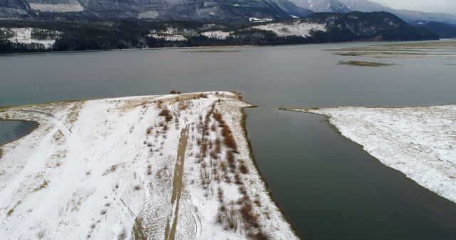 Aerial View of Snow-Covered Landscape by a Lake in Winter - Download Free Stock Images Pikwizard.com