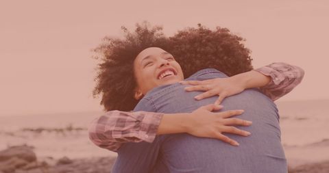 Joyful Couple Embracing at Beach During Vacation