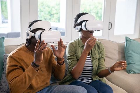 Couple Experiencing Virtual Reality in Home Living Room