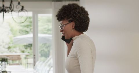 African american woman engaging in mobile communication at home