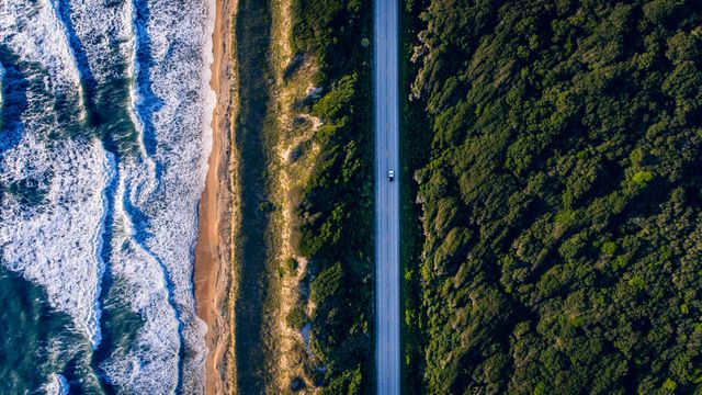 Aerial view of landscape with mountain, road and sea. nature and travel concept