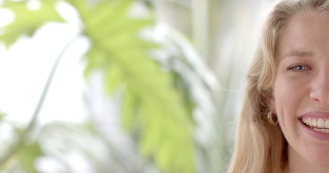 Smiling Young Woman with Blonde Hair and Plants Background - Download Free Stock Images Pikwizard.com