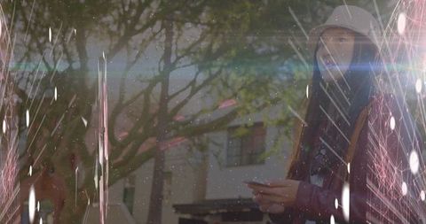 Woman outside holding smartphone with urban street style