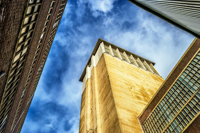 Low Angle Shot of Industrial Buildings Against Sky - Download Free Stock Images Pikwizard.com