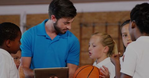Coach Using Tablet for Kids' Basketball Training Session - Download Free Stock Images Pikwizard.com