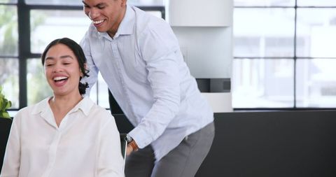 Colleagues having fun in contemporary office environment