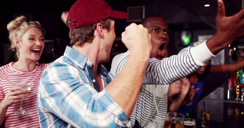 Friends Cheering and Enjoying Arm Wrestling at Bar - Download Free Stock Images Pikwizard.com