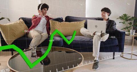 Collaborating on data analytics from couch using laptop and headphones with green graph