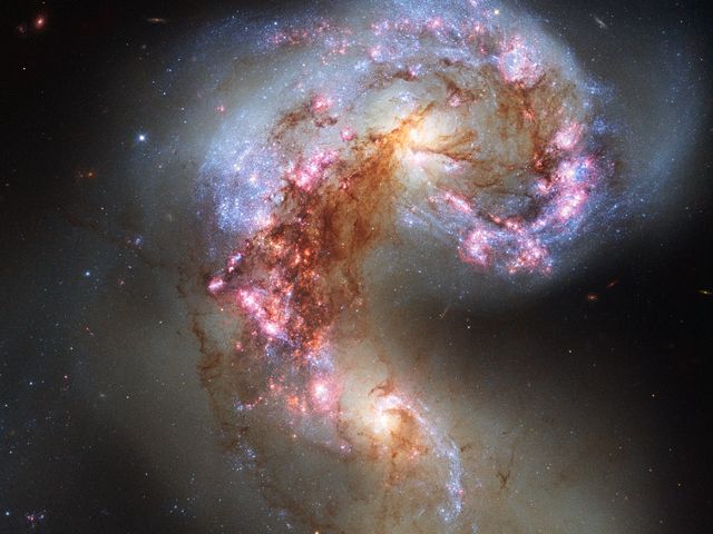 Image showcases the collision of the Antennae Galaxies, revealing intense star formation and cosmic interaction. Ideal for use in educational materials, space and astronomy documentaries, sci-fi illustrations, and science blogs.