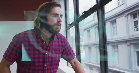 Man in Modern Office Observing Through Futuristic Display