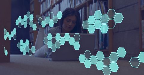 Student Using Laptop with Hexagonal Elements in Library