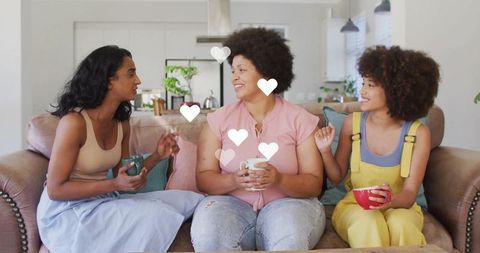 Group of Women Enjoying Casual Conversation on Comfortable Sofa