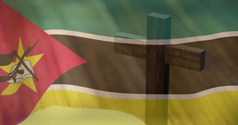 Wooden christian cross standing against mozambique flag overlay symbolizing faith, heritage