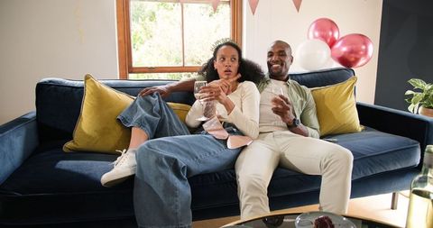 Diverse Couple Enjoying Drinks While Relaxing at Home