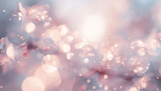 Shimmering pastel bokeh with soft glowing orbs and dreamy light flare