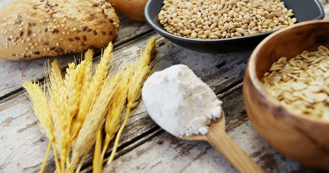 Displaying natural and fresh baking ingredients on a rustic wooden table, this scene emphasizes organic and wholesome matters. It is perfect for illustrating topics related to baking, organic cooking, artisanal breads, healthy eating, and farm-to-table practices. Use it in blog posts, cooking websites, bakery promotions, agricultural advertisements, or nutritional articles.