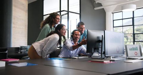 Multiracial Team Celebrating Business Success in Modern Office