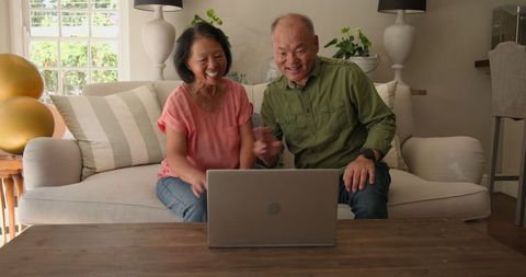 Senior Couple Video Chatting Happily at Home Together