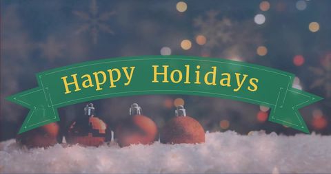 Festive Happy Holidays Banner with Christmas Snow and Ornaments