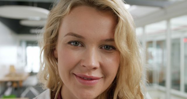 Confident Professional Woman Smiling at the Camera in Office - Download Free Stock Images Pikwizard.com