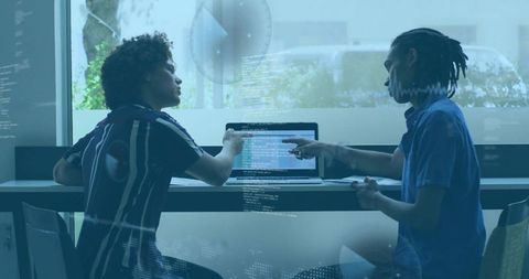 Developers Collaborating On Code Revision In Modern Office