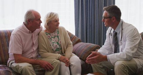 Senior Couple Counseling with Doctor at Home during Pandemic