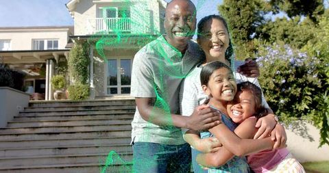 Family hugging and smiling on front steps of suburban home with green digital distortion
