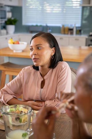 Warm Family Moment Mother and Daughter Chat in Cozy Kitchen