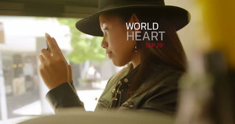 Woman on Bus Using Smartphone for World Heart Day Awareness
